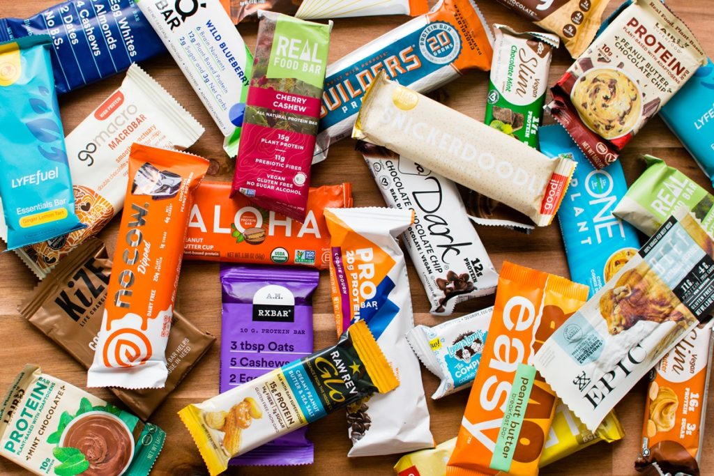 An assortment of protein bars in a variety of colors in a blog post about eating enough protein titled "Are you Eating enough protein?".